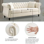 Beige velvet three-seater sofa with rolled-up armrests and rivet decorations; seats 3 people.
