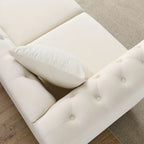 Beige velvet three-seater sofa with rolled-up armrests and rivet decorations; seats 3 people.