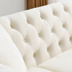 Beige velvet three-seater sofa with rolled-up armrests and rivet decorations; seats 3 people.